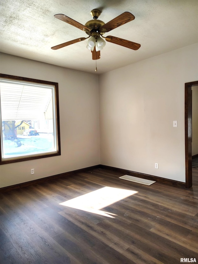 spare room featuring dark hardwood / wood-style floors and ceiling fan