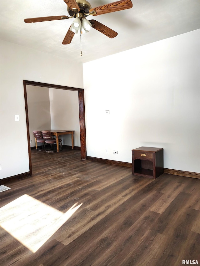 spare room with dark hardwood / wood-style floors and ceiling fan