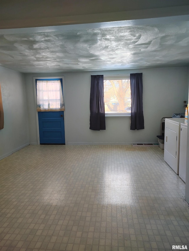 spare room with independent washer and dryer and a wealth of natural light