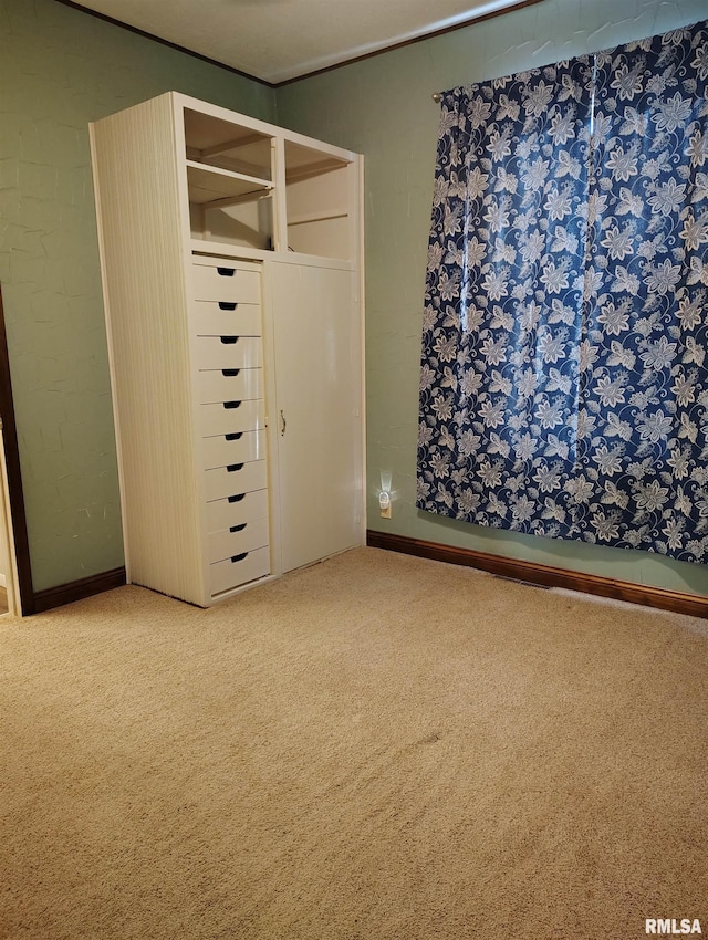 unfurnished bedroom with carpet and a closet