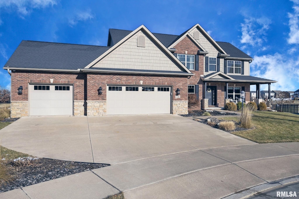 craftsman inspired home with a garage and a porch