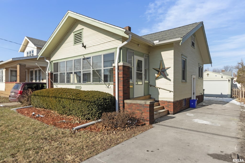 view of front of home featuring a garage and an outdoor structure