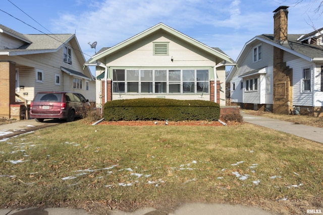 bungalow-style house featuring a front yard