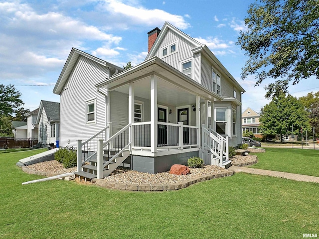 view of front of property with covered porch and a front lawn