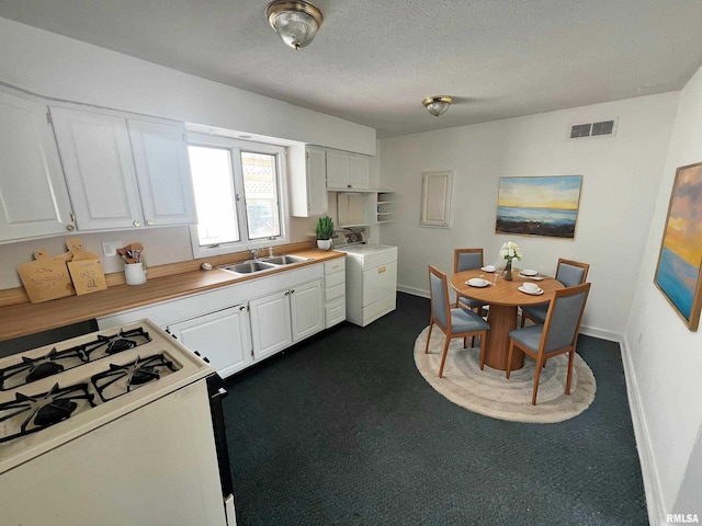 kitchen with white cabinets, washer / clothes dryer, sink, and white range with gas cooktop