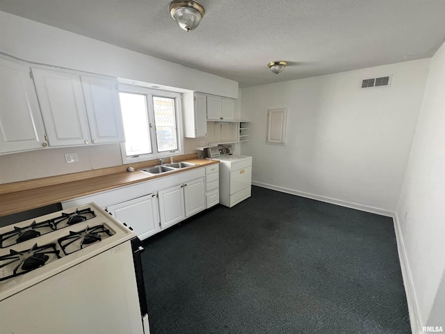 kitchen featuring white cabinets, washer / clothes dryer, white range with gas stovetop, and sink