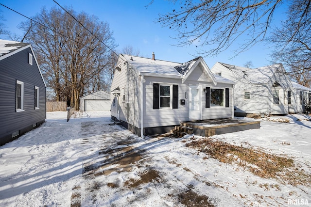 bungalow-style home with an outbuilding and a garage