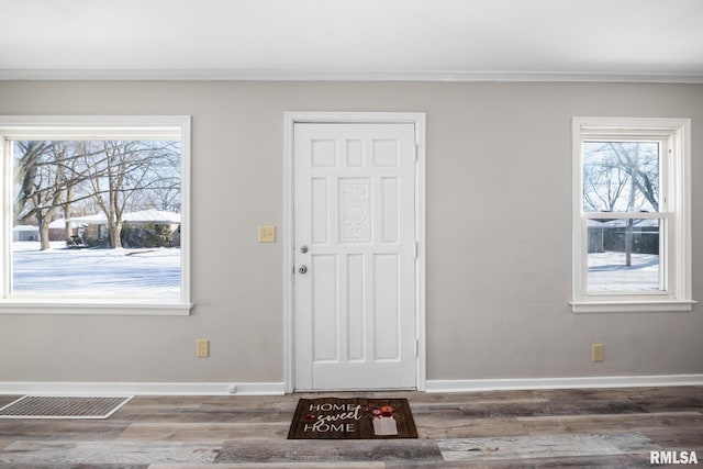 entrance foyer with crown molding and hardwood / wood-style floors