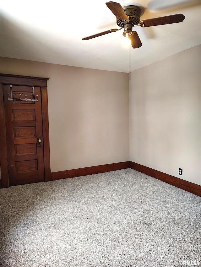 unfurnished room featuring carpet flooring, baseboards, and a ceiling fan