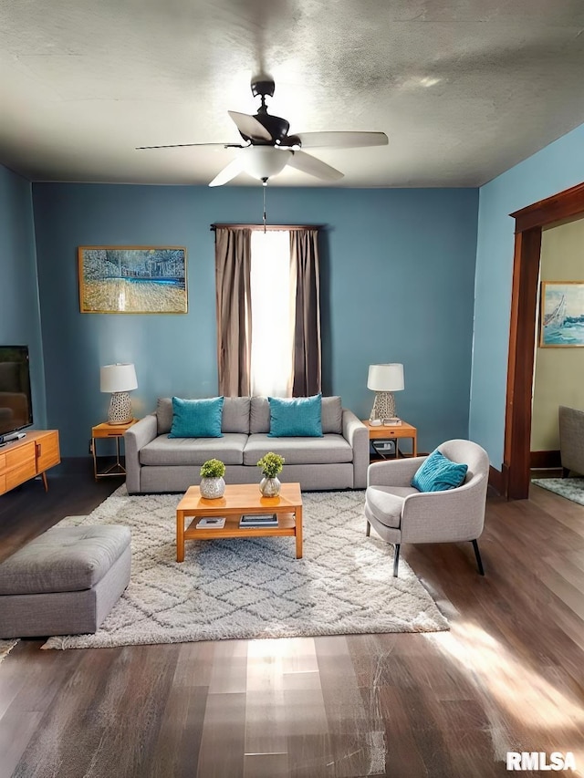 living area with wood finished floors and ceiling fan