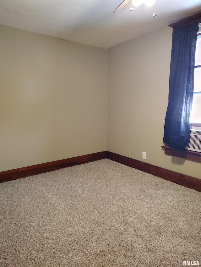 carpeted spare room with baseboards