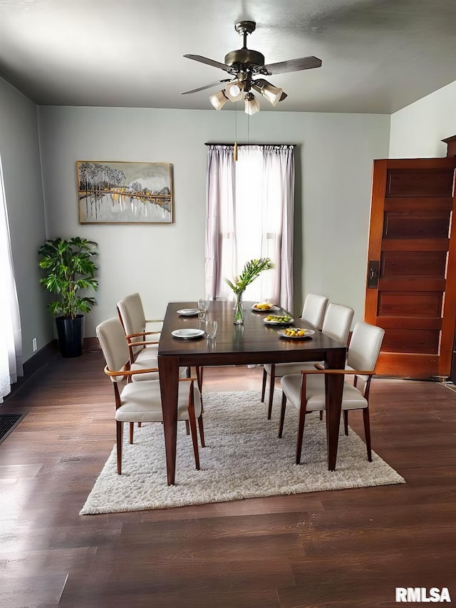 dining area with dark wood-style floors and a ceiling fan