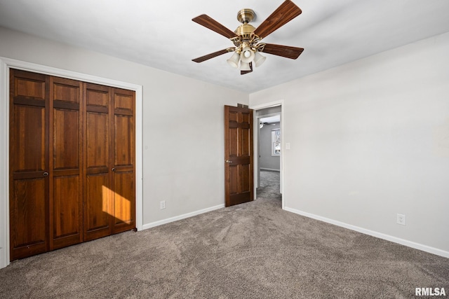 unfurnished bedroom featuring ceiling fan, a closet, and carpet flooring