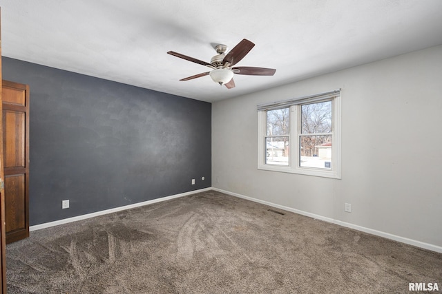 empty room with carpet floors and ceiling fan