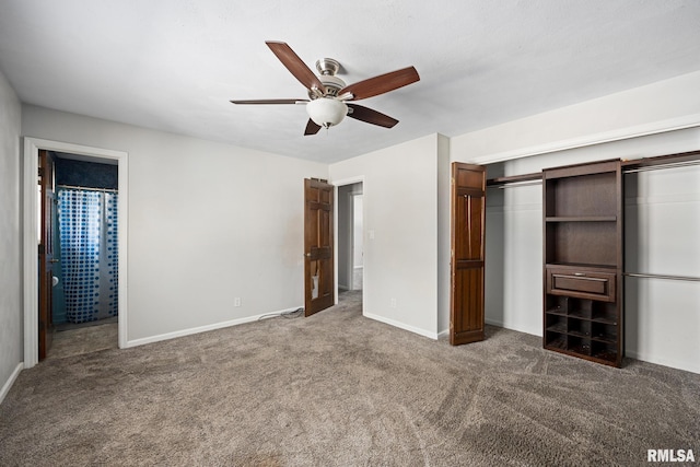 unfurnished bedroom featuring ceiling fan, connected bathroom, a closet, and dark carpet