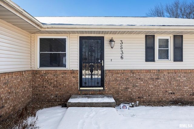 view of snow covered property entrance