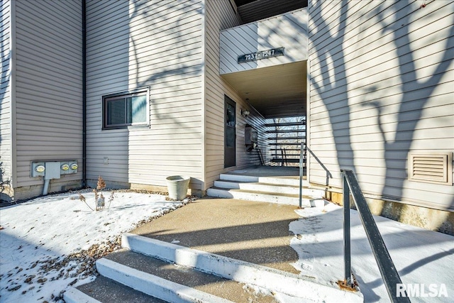 view of snow covered property entrance