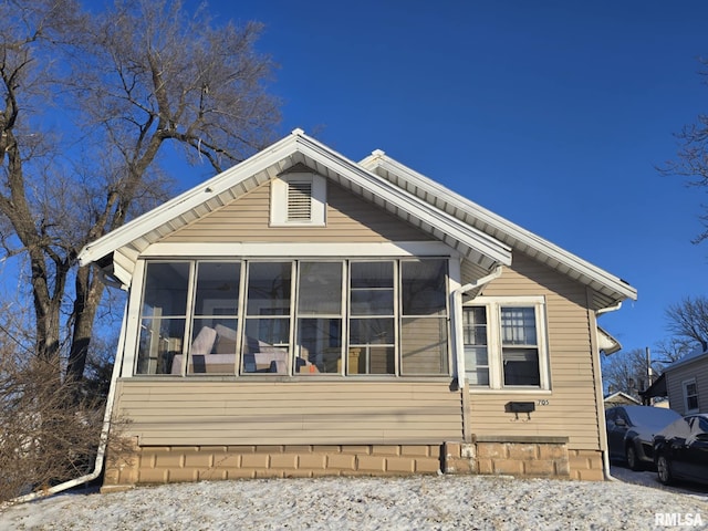 view of property exterior featuring a sunroom