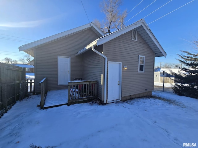 view of snow covered back of property