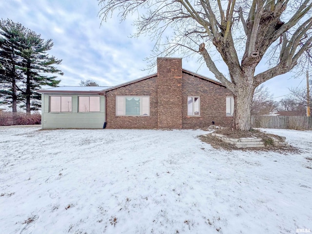 view of snow covered rear of property