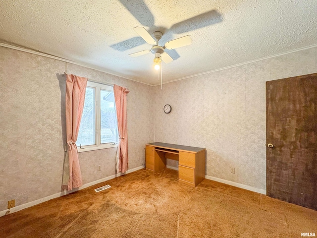 carpeted spare room with ceiling fan, ornamental molding, and a textured ceiling