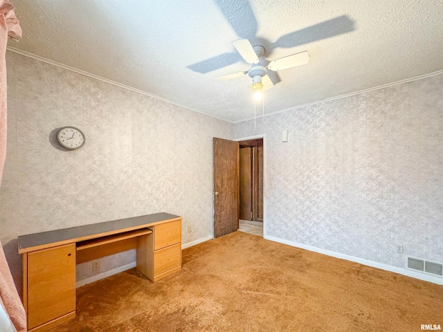 interior space featuring ornamental molding, light colored carpet, and a textured ceiling