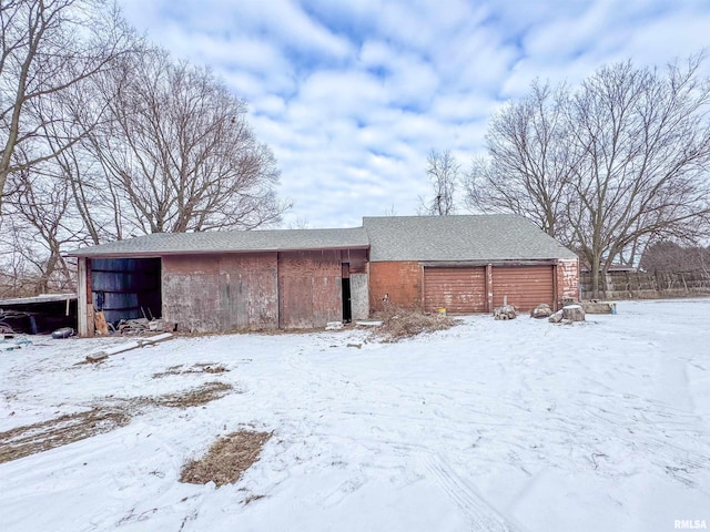 view of snow covered rear of property