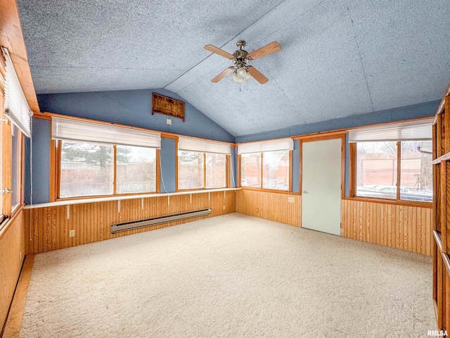 unfurnished sunroom featuring a baseboard heating unit, ceiling fan, and vaulted ceiling