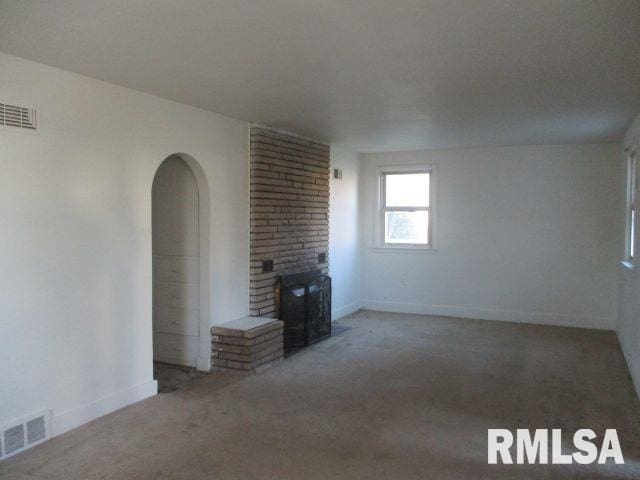 unfurnished living room with a fireplace and carpet flooring