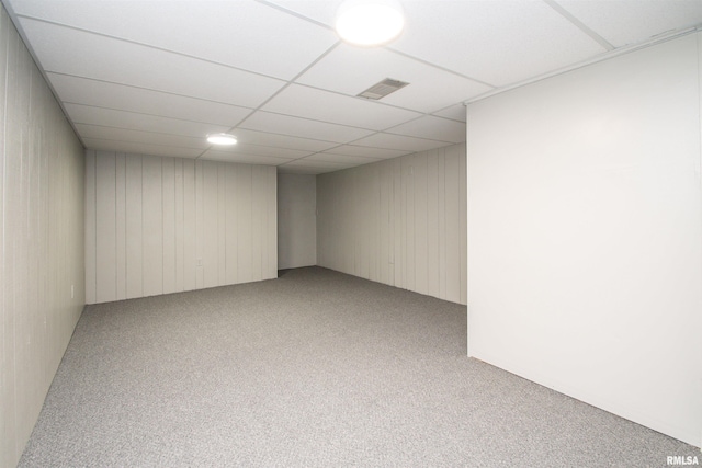 unfurnished room with a paneled ceiling and light carpet