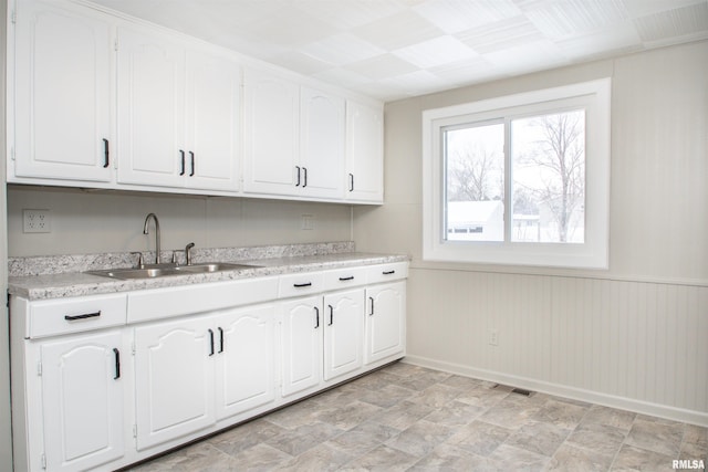 kitchen with sink and white cabinetry