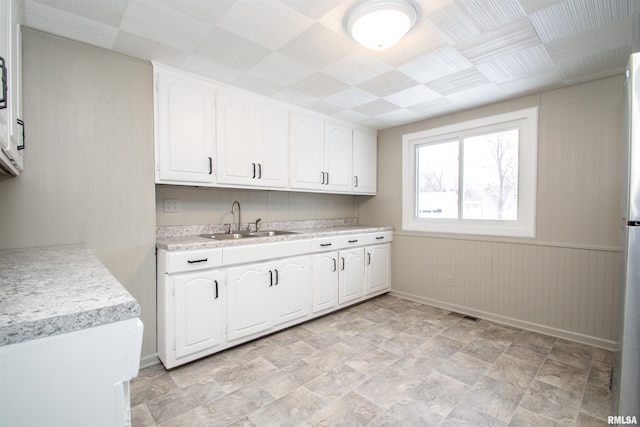 kitchen featuring sink and white cabinets