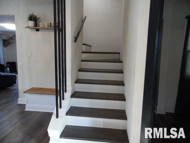 stairway featuring hardwood / wood-style floors