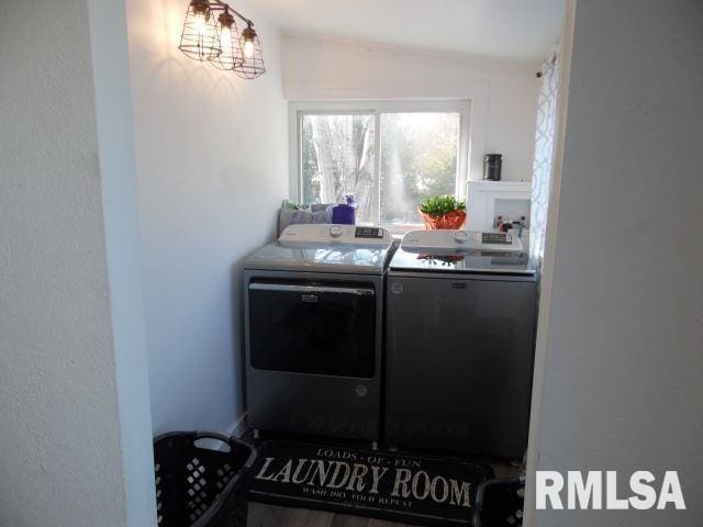 clothes washing area featuring separate washer and dryer