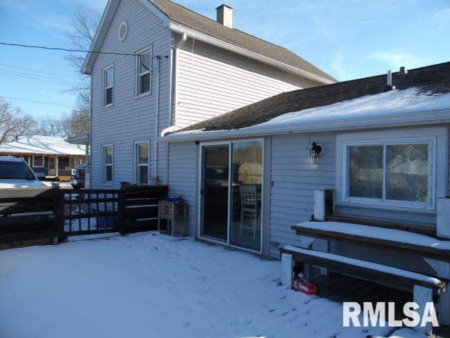 view of snow covered rear of property