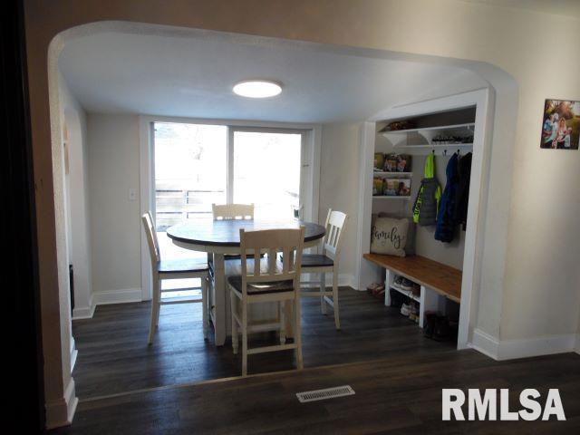 dining room with dark hardwood / wood-style flooring