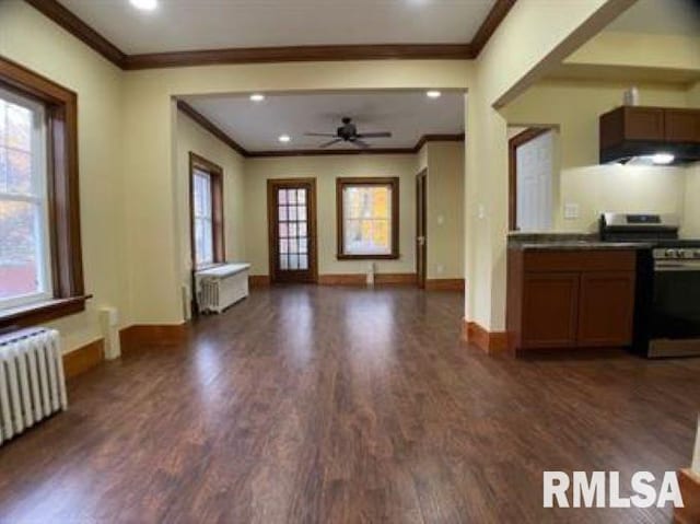 kitchen featuring radiator, stainless steel stove, dark hardwood / wood-style floors, ornamental molding, and ceiling fan