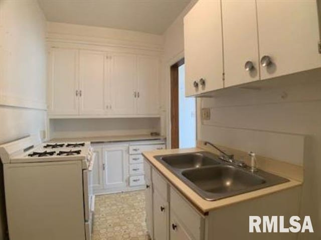 kitchen with sink, white cabinetry, and white gas range oven