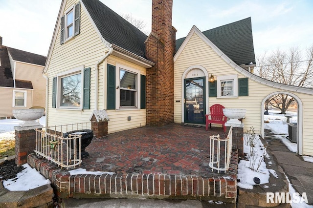 snow covered property with cooling unit