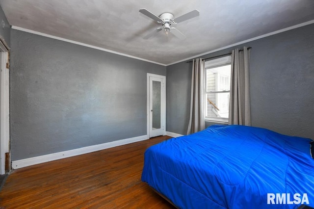 unfurnished bedroom featuring ceiling fan, dark wood-type flooring, and crown molding