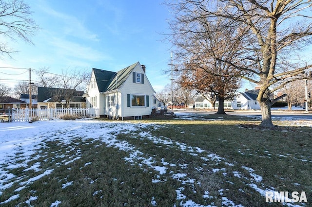 view of snow covered exterior with a yard