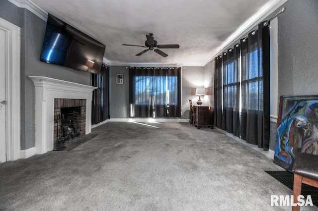 unfurnished living room with carpet floors, ceiling fan, a brick fireplace, and ornamental molding