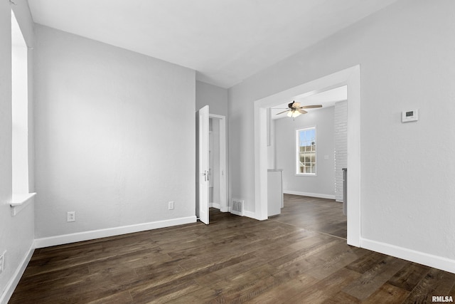 unfurnished room featuring dark wood-type flooring and ceiling fan