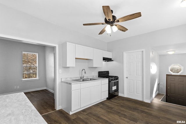 kitchen with dark wood-type flooring, sink, black gas stove, ceiling fan, and white cabinets