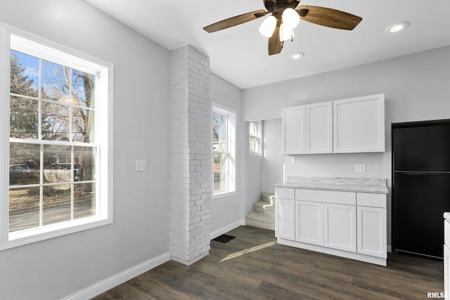 kitchen featuring black fridge, white cabinetry, ceiling fan, and dark wood-type flooring