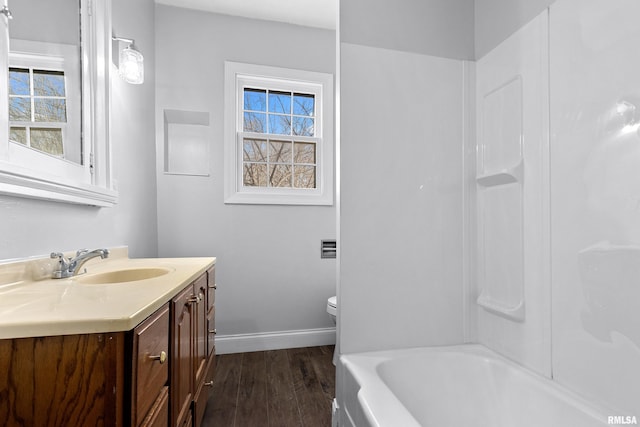 full bathroom with vanity, hardwood / wood-style floors, a wealth of natural light, and toilet