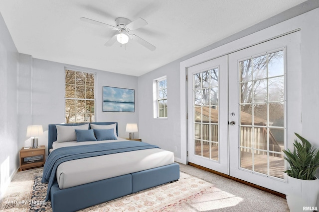 carpeted bedroom with french doors, ceiling fan, and access to exterior