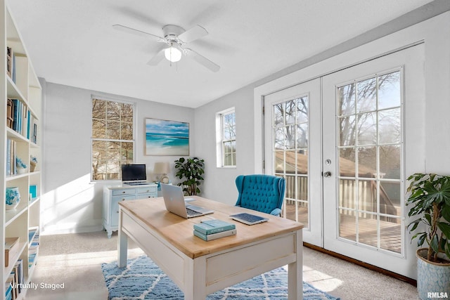 office with light colored carpet, ceiling fan, and french doors