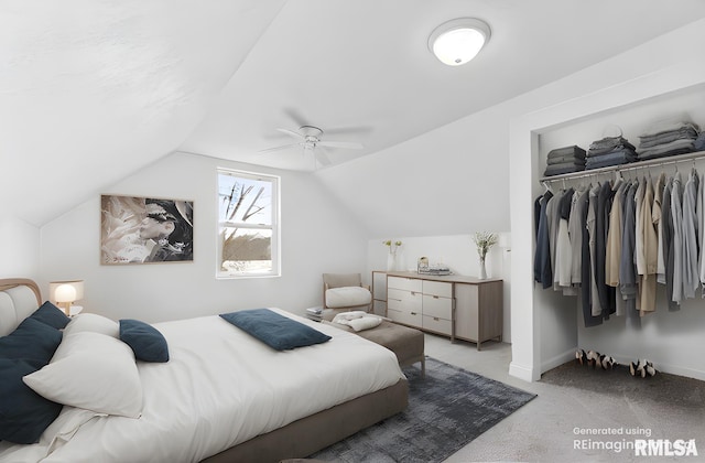 bedroom with vaulted ceiling, light carpet, ceiling fan, and a closet