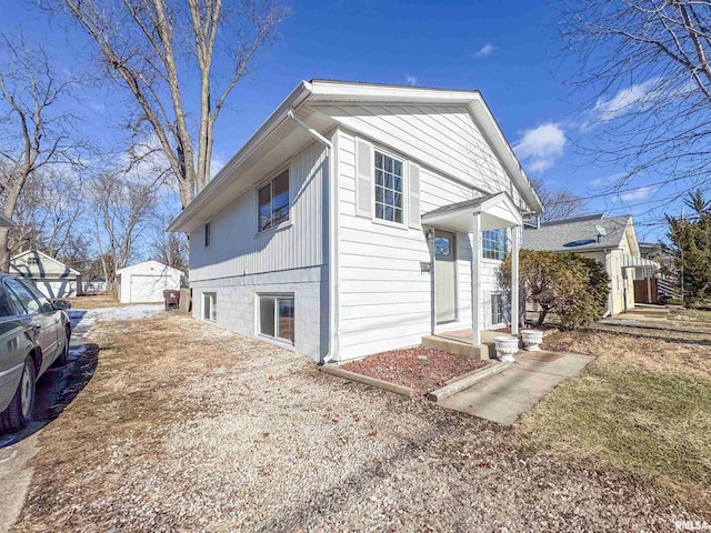 view of home's exterior featuring an outbuilding and a garage